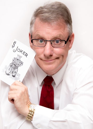Timothy Pitch holding a Joker playing card