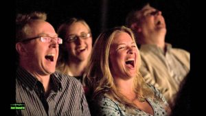 audience members laughing at comedy performer