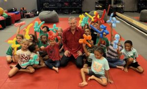 Tampa Bay area children's magician Timothy Pitch sitting with children on a mat