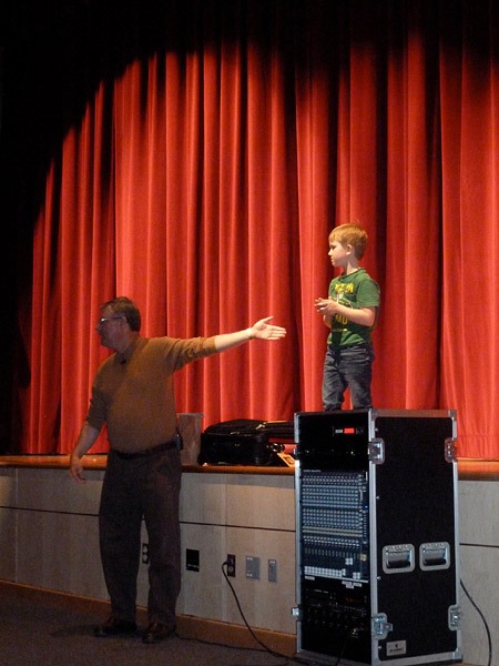 Tampa Bay area preschool magician for hire Timothy Pitch with a child onstage